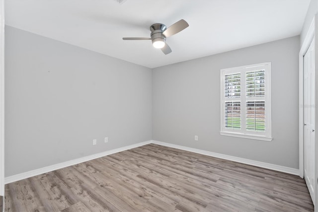 spare room featuring light hardwood / wood-style floors and ceiling fan