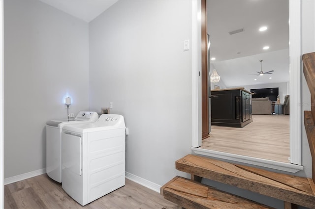 washroom with independent washer and dryer and light hardwood / wood-style floors