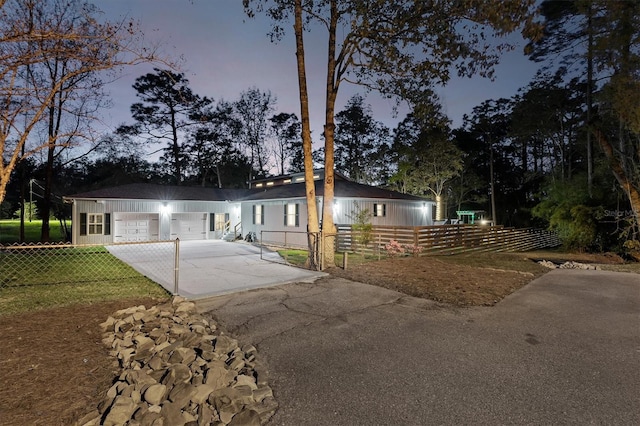 ranch-style home with a garage and a lawn