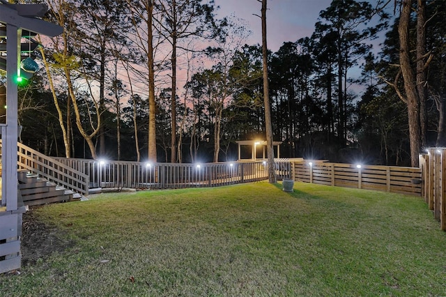 view of yard at dusk