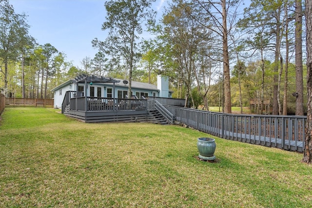 back of house with a wooden deck, a pergola, and a lawn