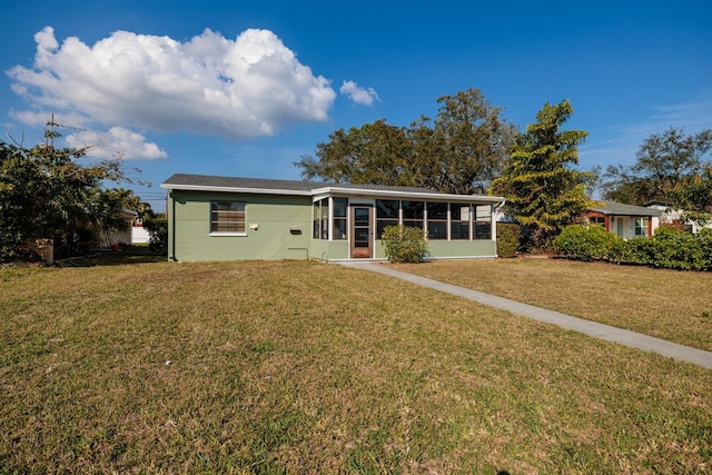 ranch-style home featuring a sunroom and a front yard