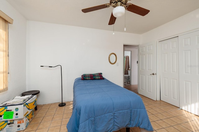 bedroom with light tile patterned floors, a closet, and ceiling fan