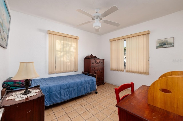 tiled bedroom featuring ceiling fan