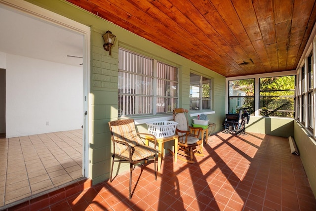 sunroom with wood ceiling and baseboard heating