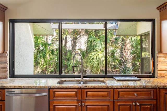 kitchen featuring plenty of natural light, sink, stainless steel dishwasher, and light stone counters