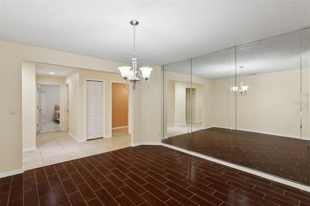 interior space with a textured ceiling and an inviting chandelier