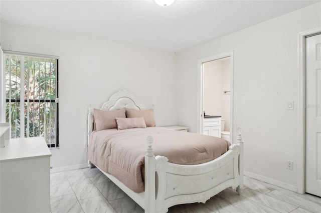 bedroom featuring connected bathroom and a textured ceiling