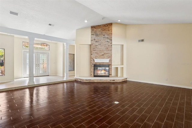 unfurnished living room with a fireplace, high vaulted ceiling, dark hardwood / wood-style flooring, and decorative columns