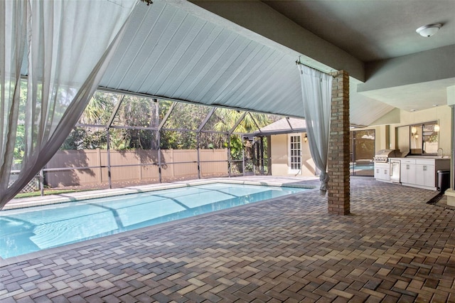 view of swimming pool featuring area for grilling, glass enclosure, and a patio