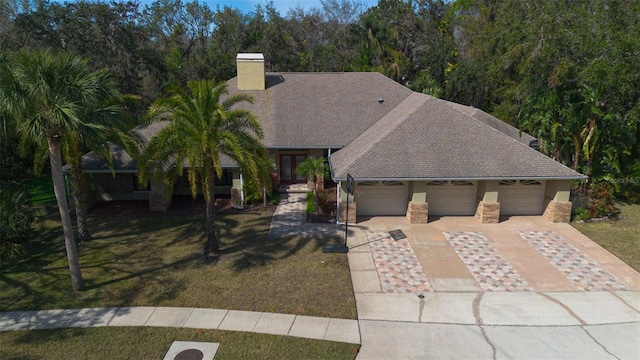 view of front of property featuring a garage and a front lawn