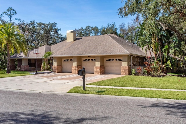 view of front facade with a front lawn, an attached garage, brick siding, and driveway