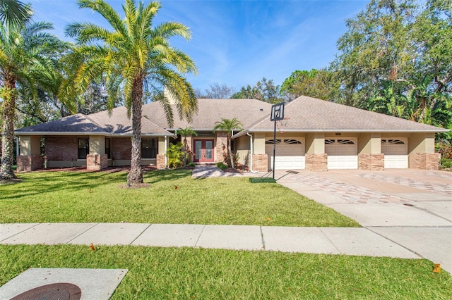 ranch-style house with stucco siding, a front lawn, french doors, concrete driveway, and an attached garage