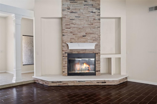 70 Deerpath Dr, Oldsmar, FL 34677 - room details with wood finish floors, visible vents, a stone fireplace, and baseboards