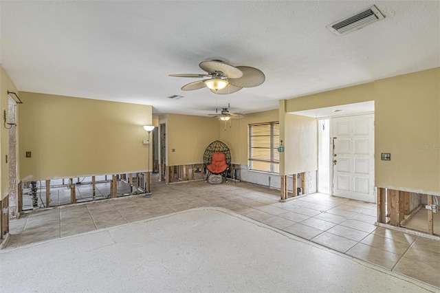 interior space featuring a textured ceiling and ceiling fan