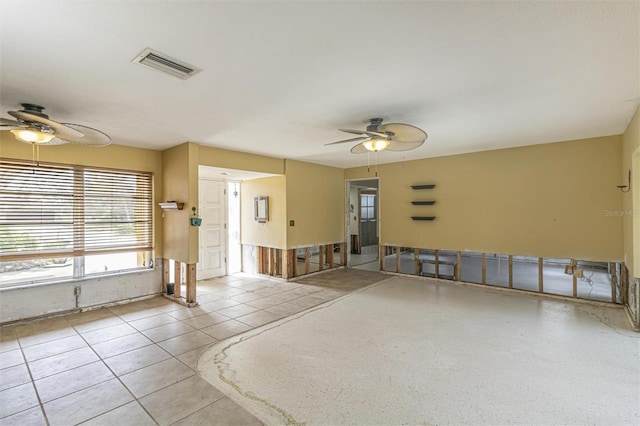 tiled empty room with ceiling fan