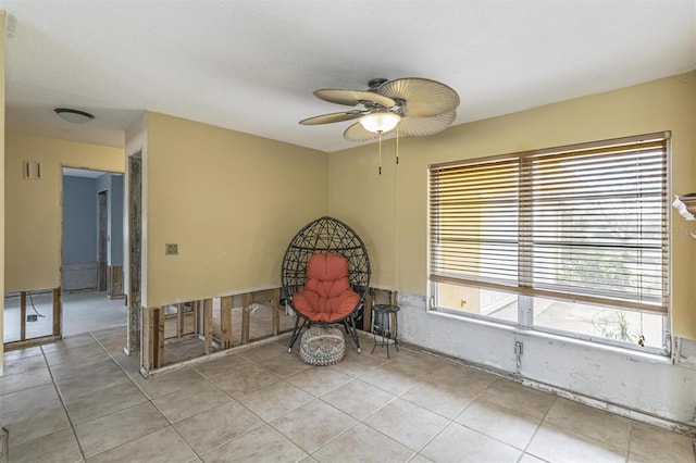 unfurnished room featuring ceiling fan, a textured ceiling, and light tile patterned floors