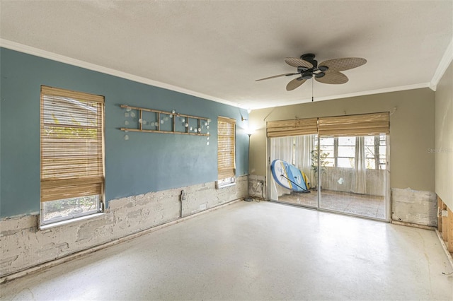 empty room featuring a textured ceiling, ornamental molding, and ceiling fan