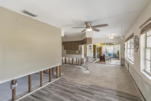 hall with a textured ceiling