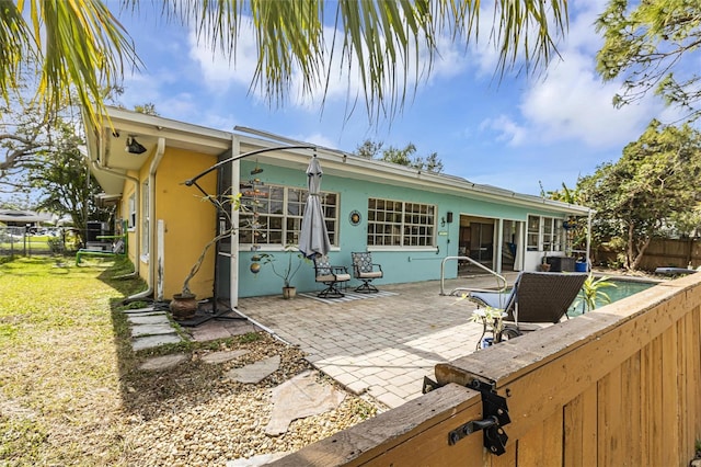 back of property with a patio