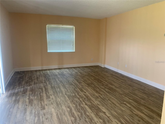 spare room featuring dark hardwood / wood-style flooring