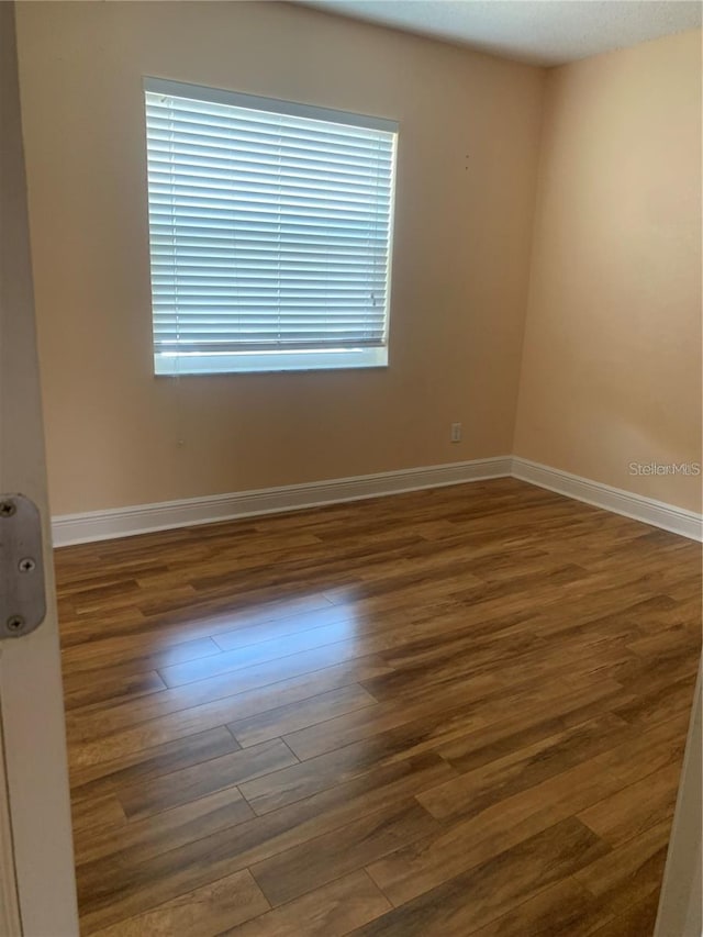 spare room featuring dark hardwood / wood-style flooring