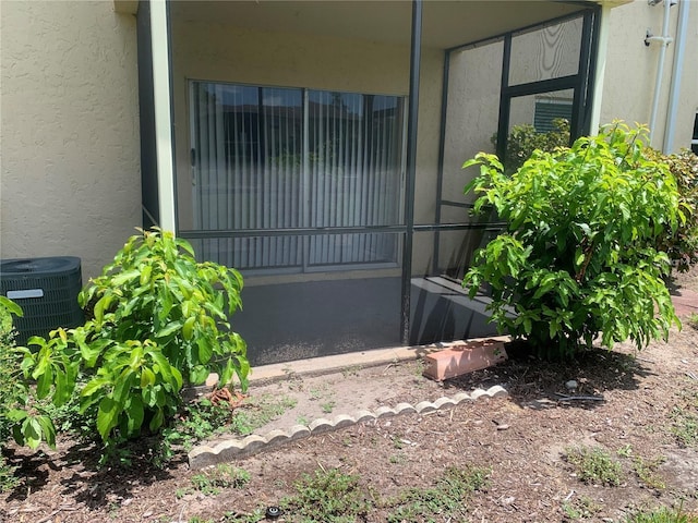 view of exterior entry with central AC unit