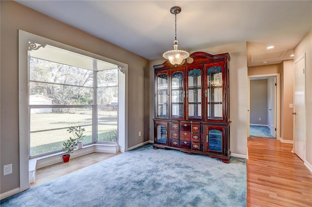 interior space featuring an inviting chandelier, hardwood / wood-style flooring, and a wealth of natural light