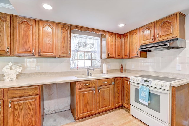 kitchen with white electric stove, tasteful backsplash, and sink