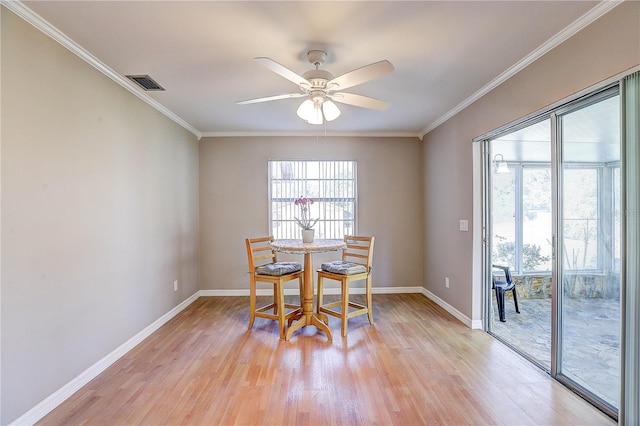 dining area with crown molding, light hardwood / wood-style flooring, and ceiling fan