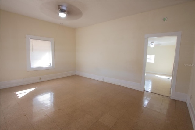 unfurnished room with a healthy amount of sunlight and ceiling fan