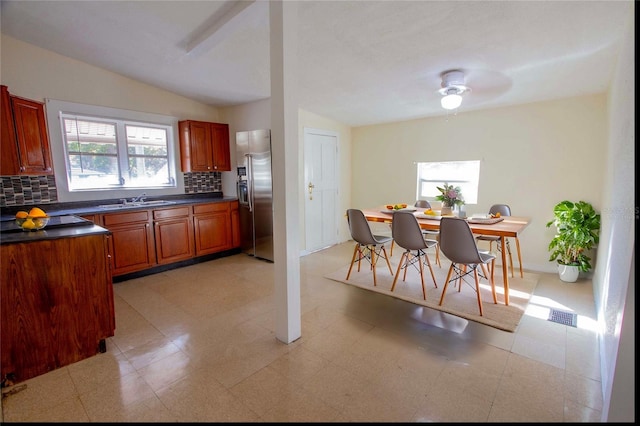 kitchen with tasteful backsplash, high quality fridge, lofted ceiling, and sink