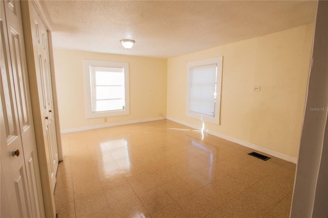 empty room with a textured ceiling