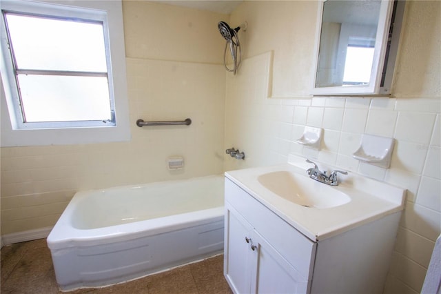 bathroom featuring tile walls, a bath, vanity, and plenty of natural light