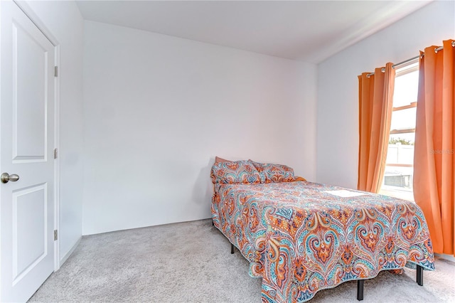 bedroom featuring light carpet