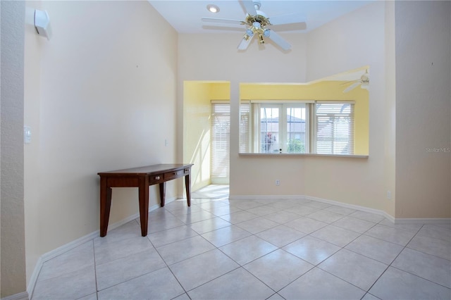 spare room with light tile patterned floors and baseboards