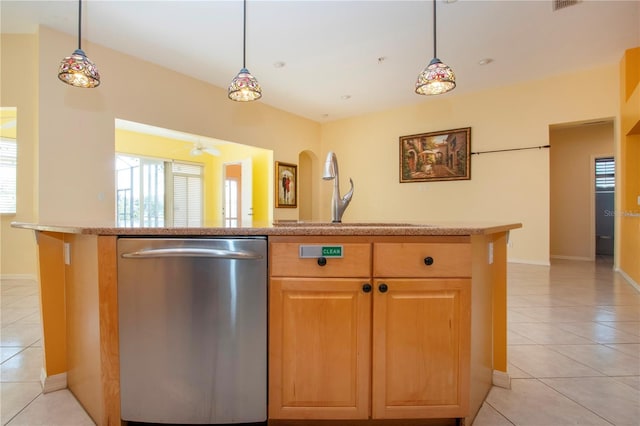 kitchen with a sink, light tile patterned floors, pendant lighting, and stainless steel dishwasher