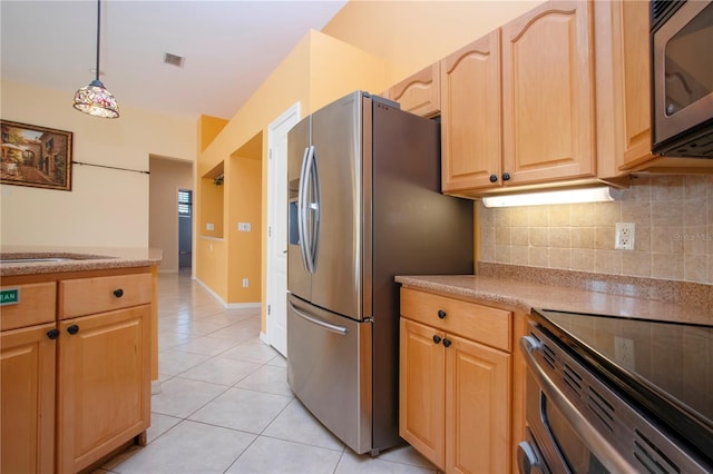 kitchen with visible vents, decorative backsplash, light brown cabinetry, appliances with stainless steel finishes, and light tile patterned flooring