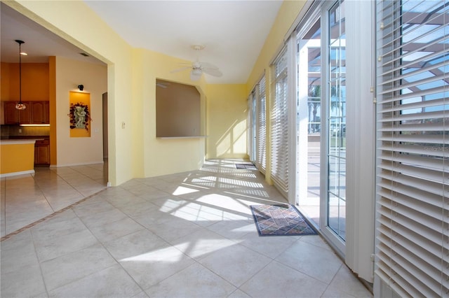 interior space featuring ceiling fan and light tile patterned floors