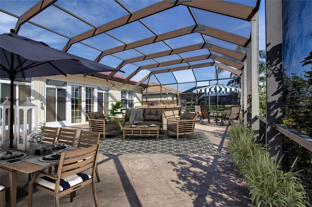 view of patio / terrace with french doors, outdoor lounge area, and a lanai