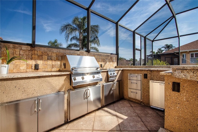 view of patio / terrace featuring an outdoor kitchen, glass enclosure, and grilling area