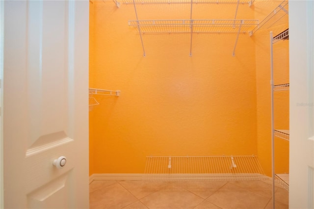 spacious closet featuring tile patterned flooring