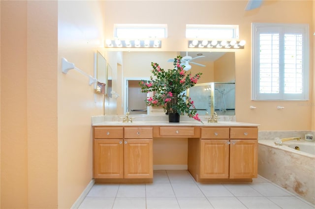 full bath featuring double vanity, a sink, a bath, and tile patterned floors