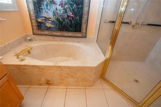 full bathroom with a garden tub, a shower stall, and tile patterned floors