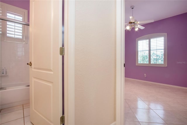 bathroom with shower / bath combination, ceiling fan, baseboards, and tile patterned floors