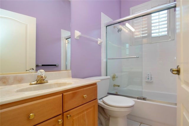 full bath with toilet, enclosed tub / shower combo, and vanity