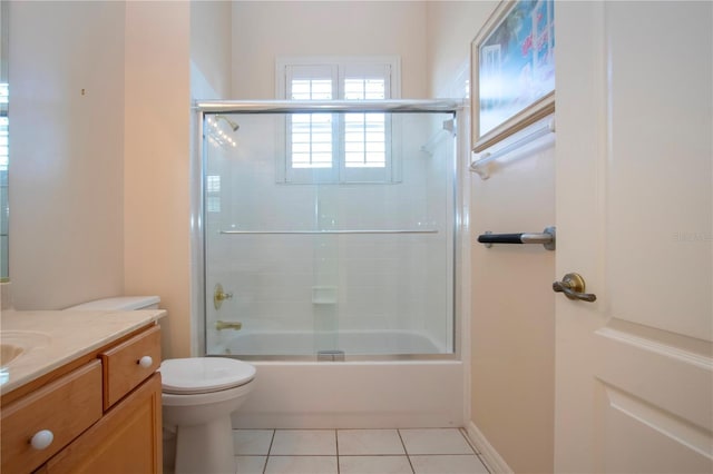 full bathroom featuring enclosed tub / shower combo, vanity, toilet, and tile patterned floors