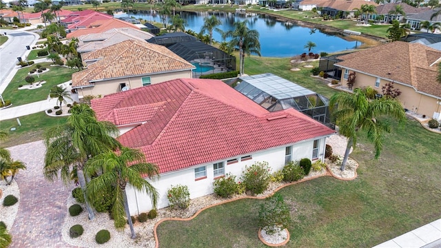 birds eye view of property with a water view and a residential view