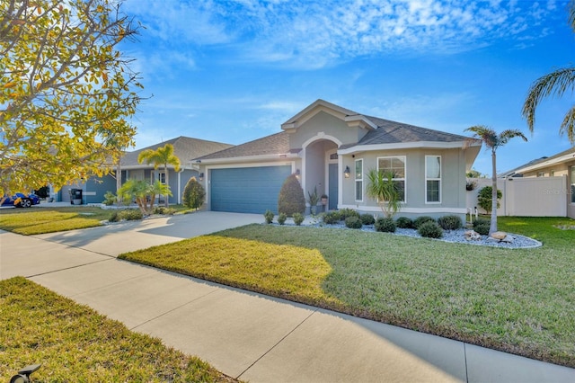 ranch-style home featuring a garage and a front yard