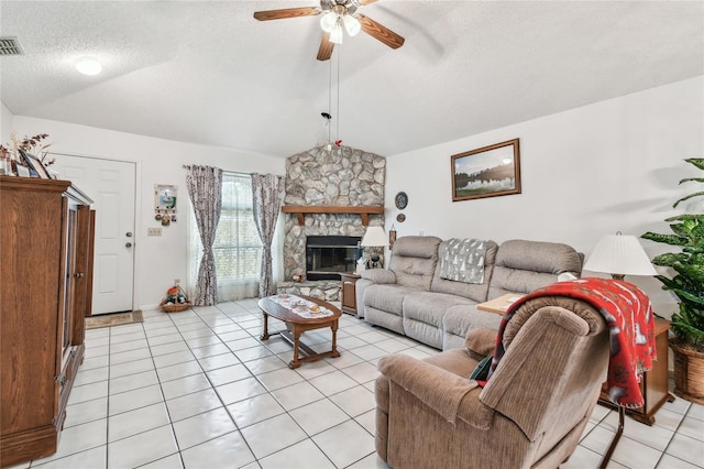 living room with light tile patterned floors, vaulted ceiling, a fireplace, and a textured ceiling